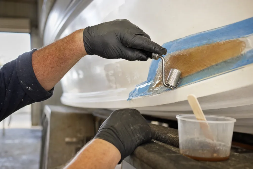 Fibreglass cloth wetted out with resin and rolled into a tapered repair